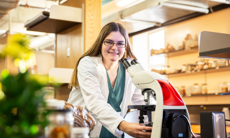 Sarah Hosler at an Albright microscope