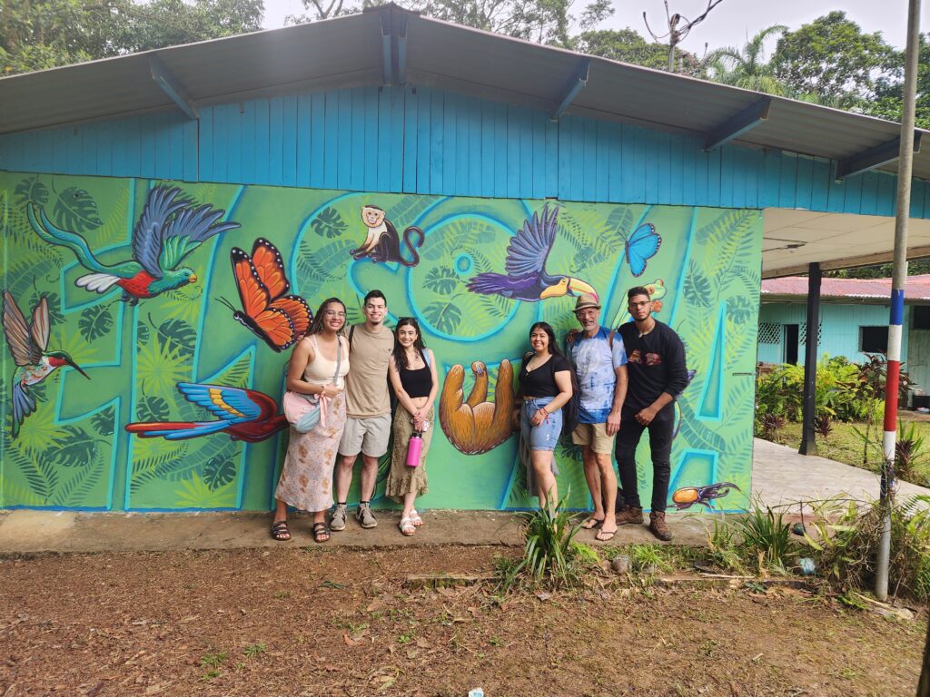 Angelica Malone, Brandom Hernandez-Ruiz, Katie Hernandez-Ayala and Anthony Ortiz-Santana with muralist and faculty mentor, Mike Miller are pictured in front of the the El Sota school mural.